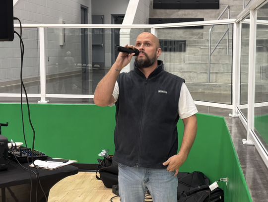Azle coach lends voice to mat with national anthem performances