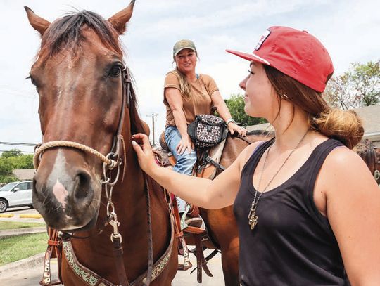 Hoofin’ it: Azle rodeo competitor takes to Main Street for sponsors