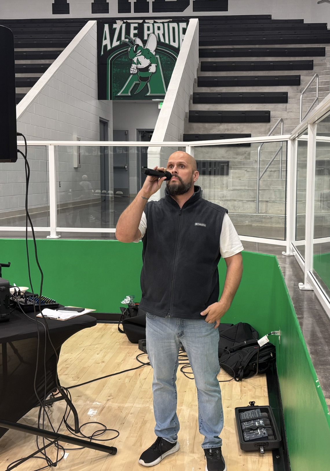 Azle coach lends voice to mat with national anthem performances